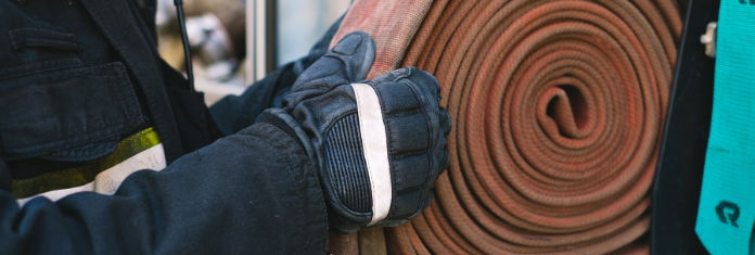 A person holding a fire hose. 